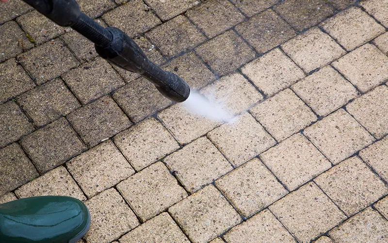 Block paving driveway being jet washed
