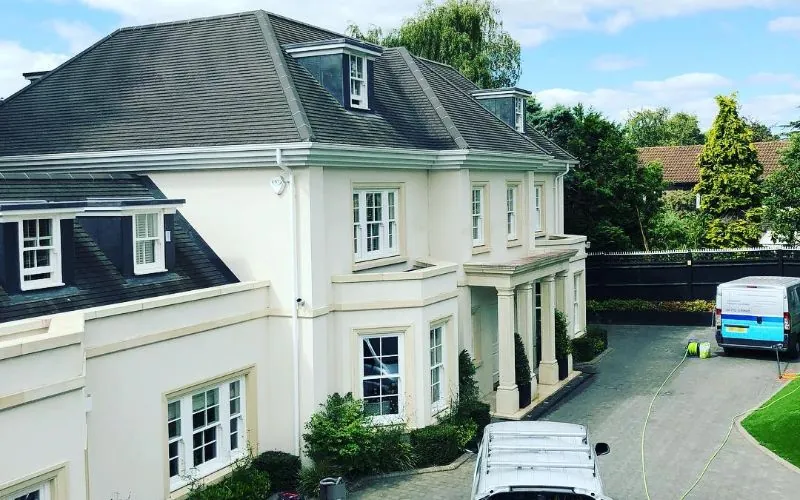 Large white house with a clean slate roof