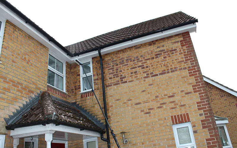 Clean white soffits and fascias on a brick house